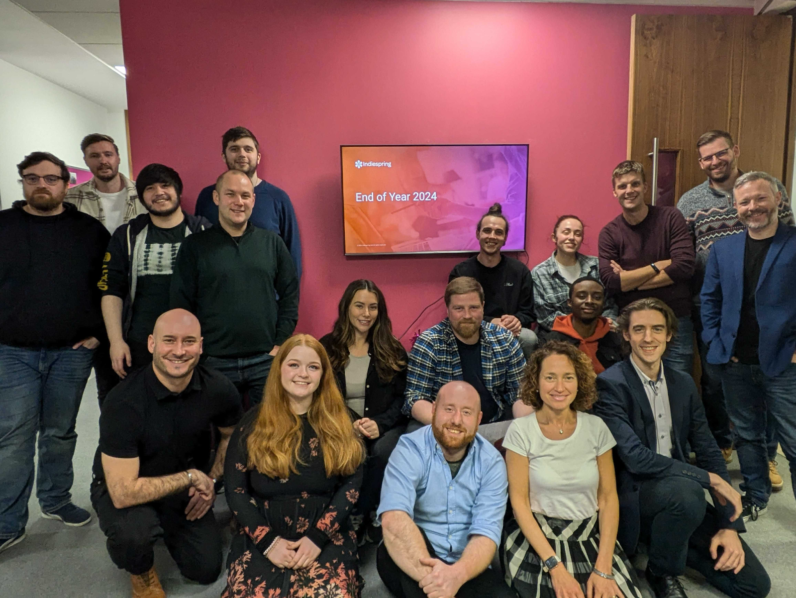 The team posing for a photo in the office